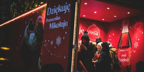 Imagine cu copii in fata unei promotii de Craciun tradusa